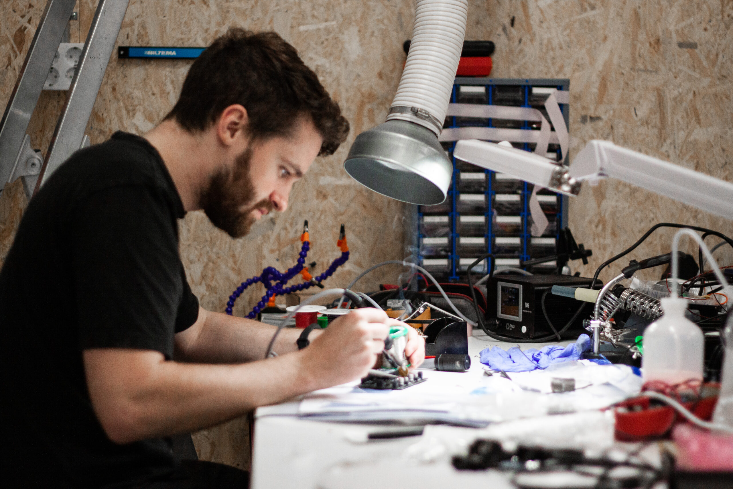A person working with electronics at oim